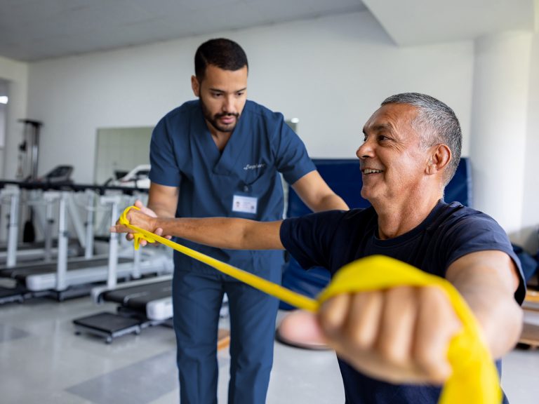 Man doing physical therapy exercises using a stretch band