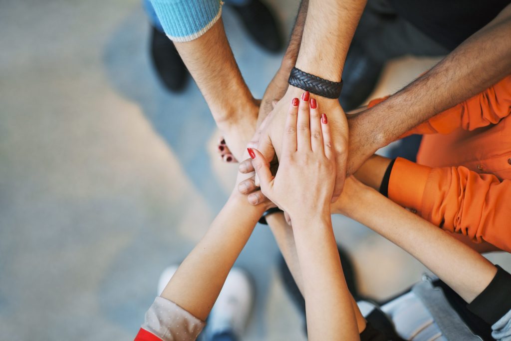 Close up image of young multiethnic students making a stack of hands