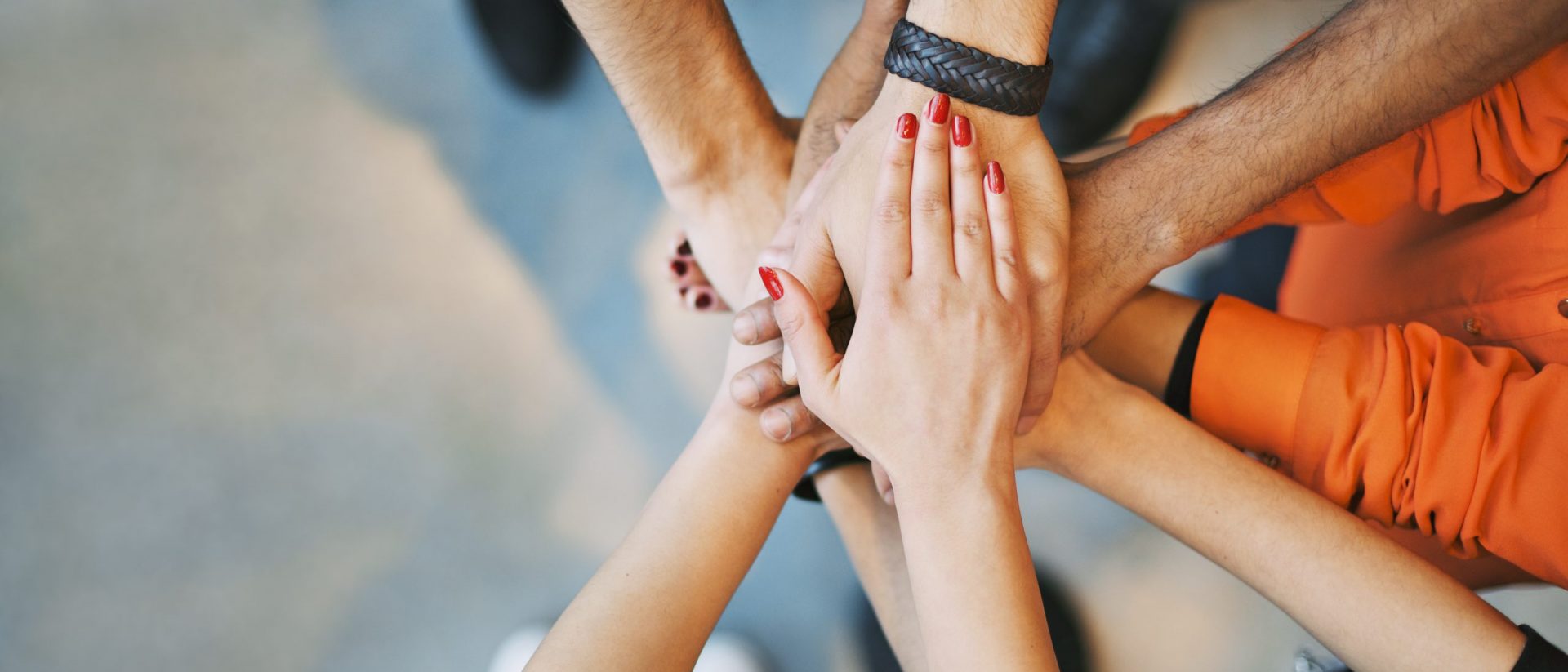 Close up image of young multiethnic students making a stack of hands